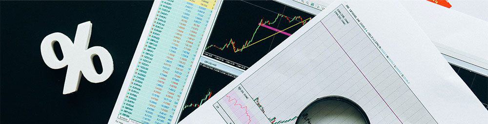 graphs on paper with magnifying glass