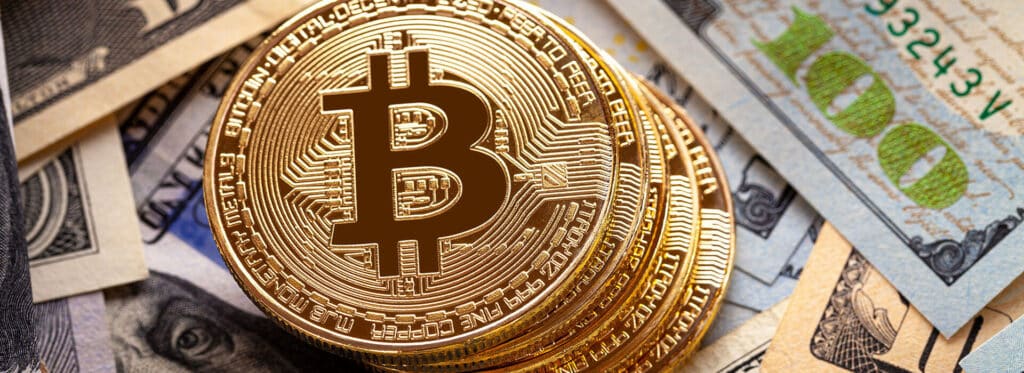 bitcoins and dollar bills