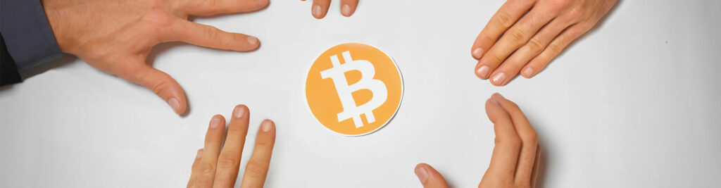 hands reaching out for bitcoin
