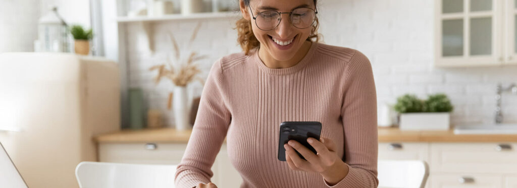 woman paying bills using smartphone