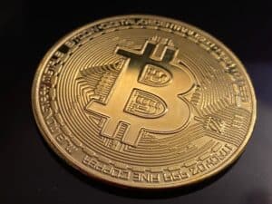 Golden bitcoin coin on dark background