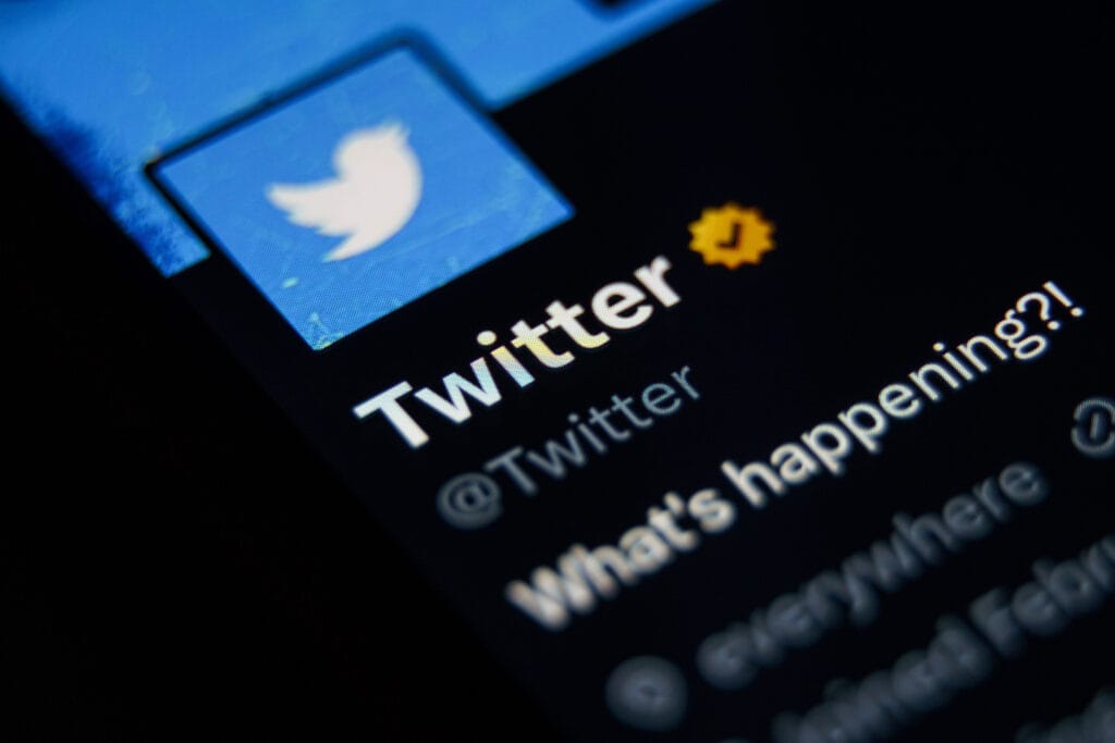 Close-up shot of twitter account At twitter. Blue verified icon checkmark