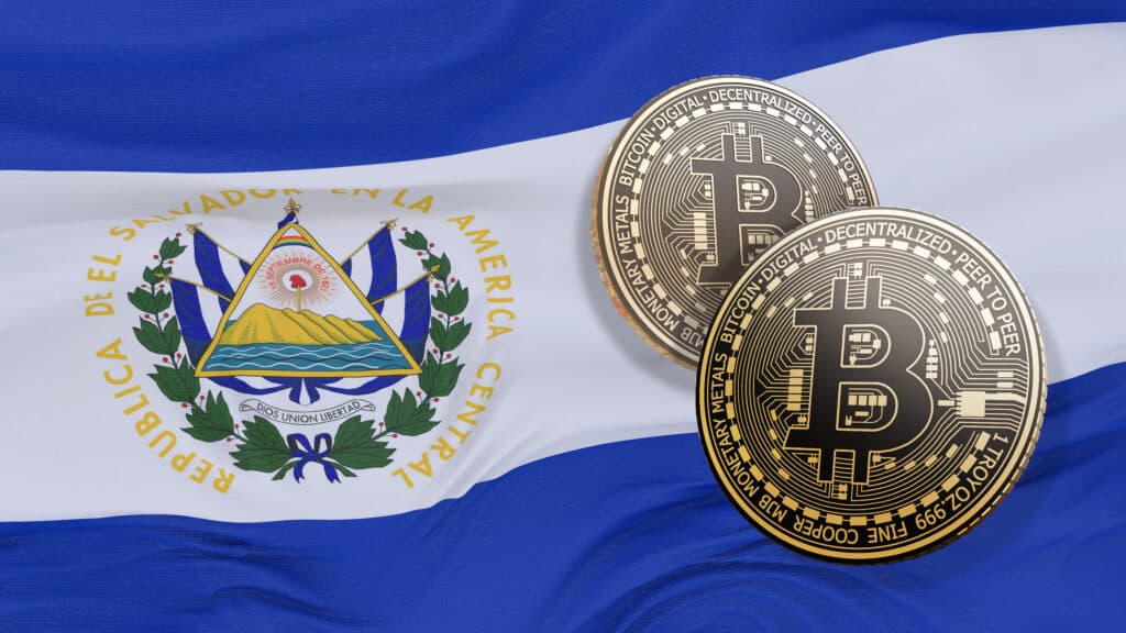 two bitcoins in front of El Salvador flag