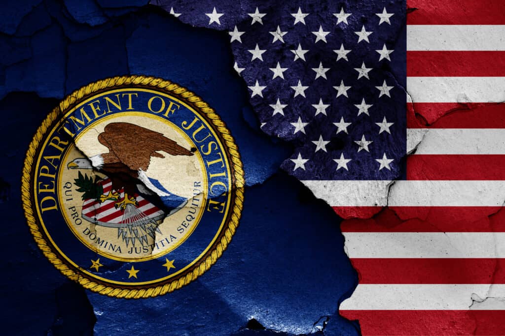 flags of Department of Justice and USA painted on cracked wall