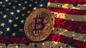 A coin with the bitcoin on it is on top of a red, white, and blue American flag