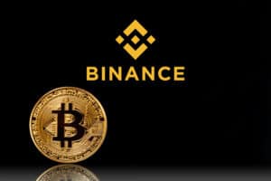 Binance logo with bitcoin on black background.