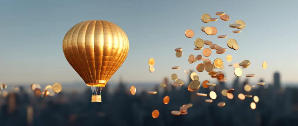 Gold coins dropping from the air beside a golden hot air balloon