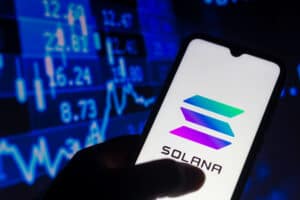 In this photo illustration the Solana logo seen displayed on a smartphone.
