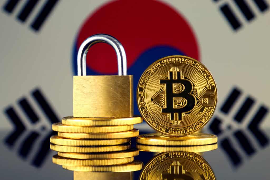 Physical version of Bitcoin, golden padlock and South Korea Flag.