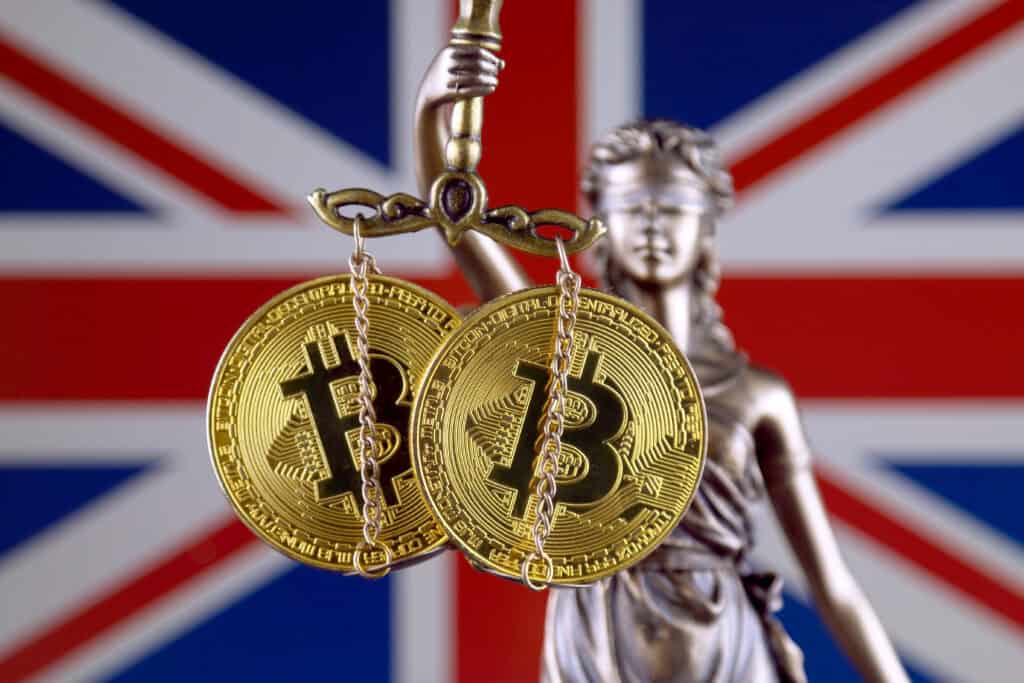Symbol of law and justice, physical version of Bitcoin and United Kingdom Flag.