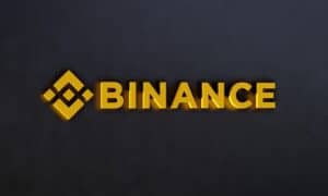 Three-dimensional Binance logo against dark wall