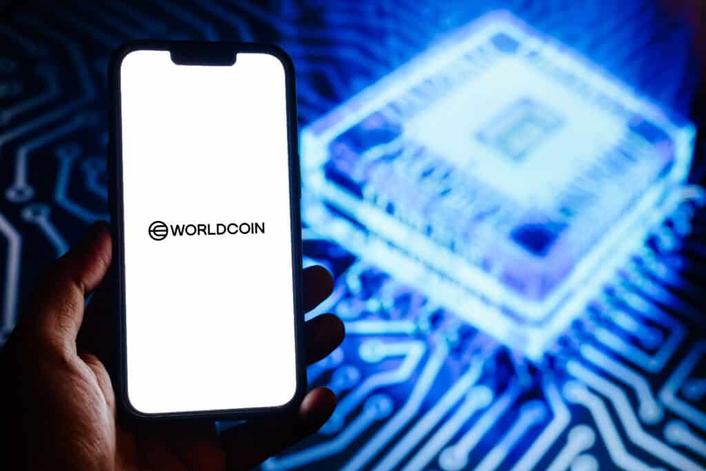 Worldcoin logo displayed on a smartphone