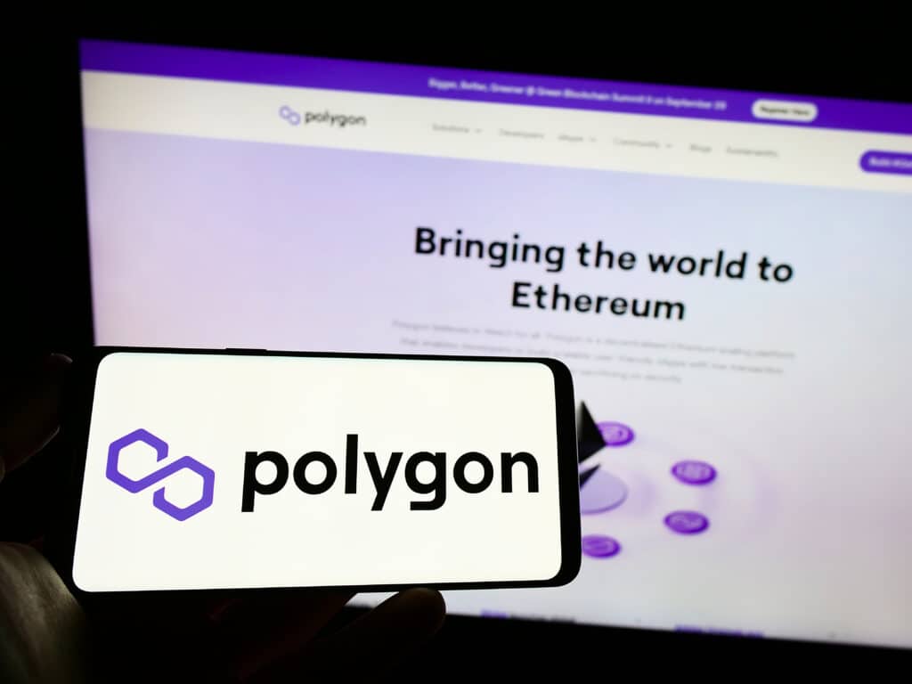 Person Holding Mobile Phone With Logo of Indian WEB3 Company Polygon Technology on Screen in Front of Business Web Page.
