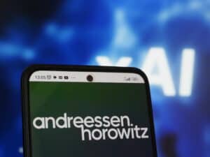 Andreessen Horowitz logo seen displayed on a smartphone on the background of xAI Corp.