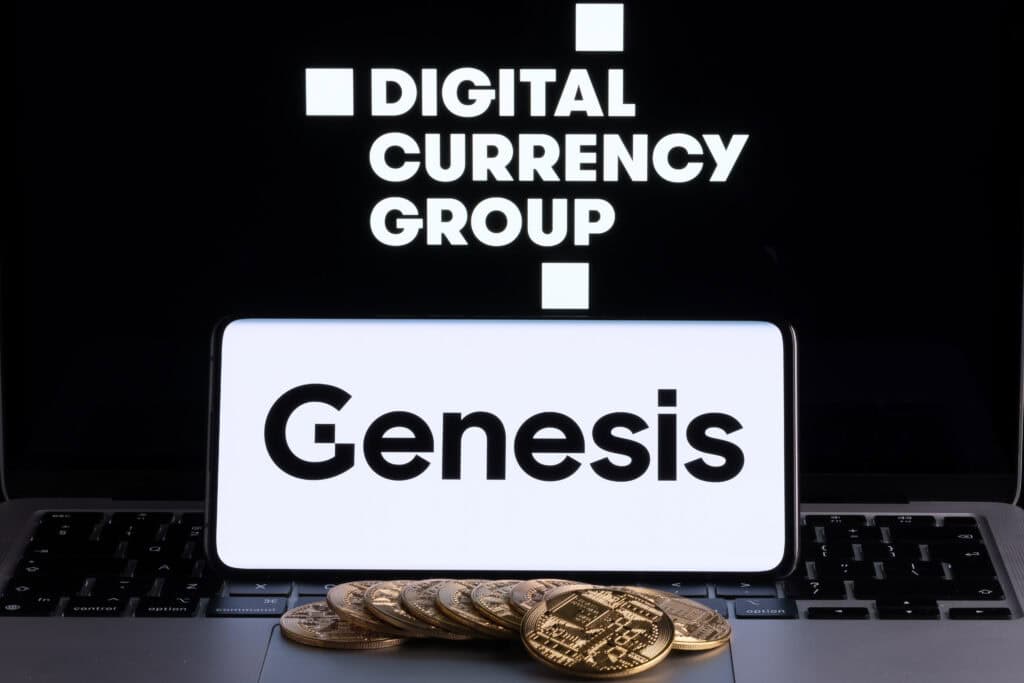 Genesis Global Trading crypto company logo seen on screen of smartphone with bitcoin tokens.