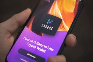 Person uses Exodus Wallet app on Apple iPhone 12.