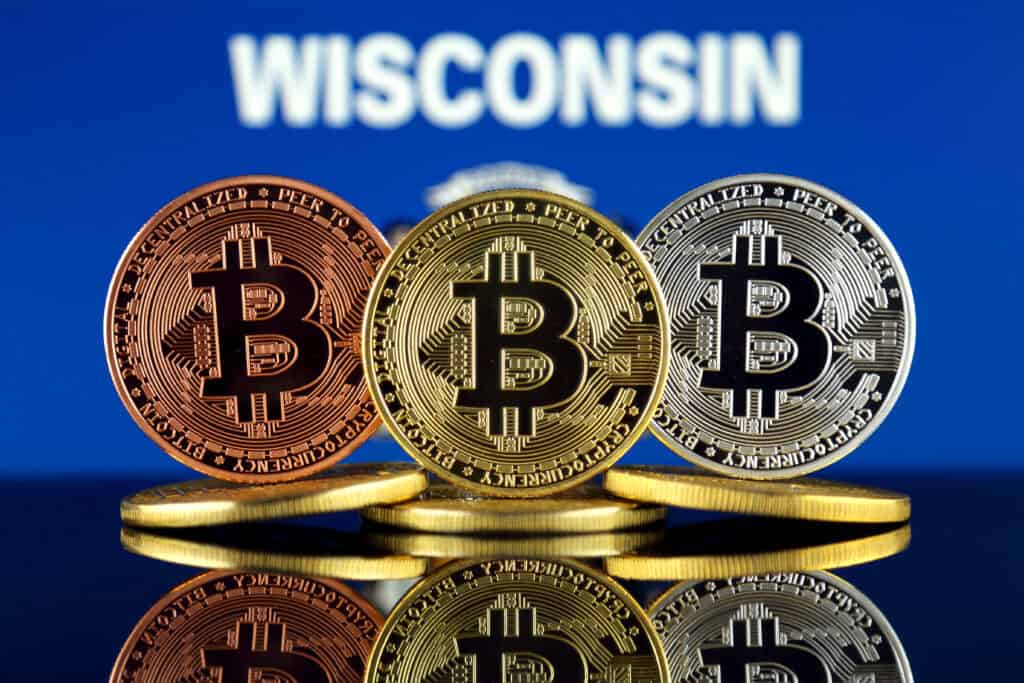 Physical version of Bitcoin (BTC) and Wisconsin State Flag.