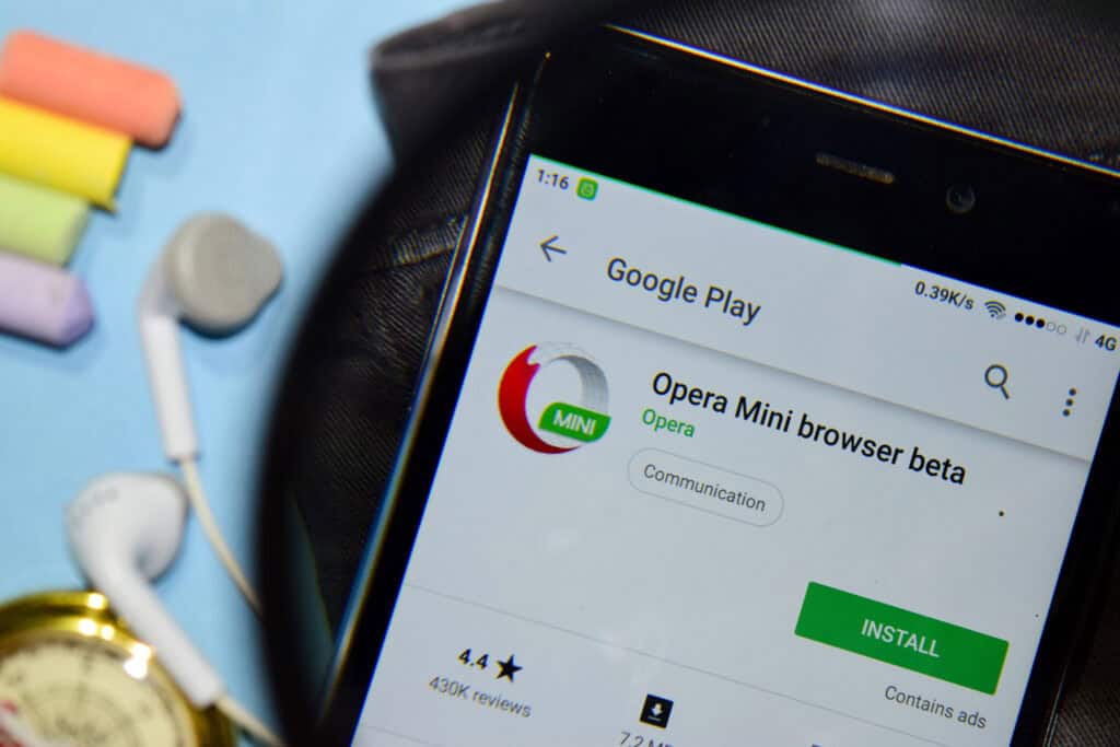 Opera Mini browser beta dev app with magnifying on Smartphone screen.