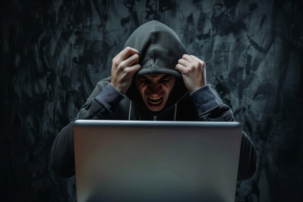 Angry hacker man in hoodie suit is screaming because he failed to hack the security system