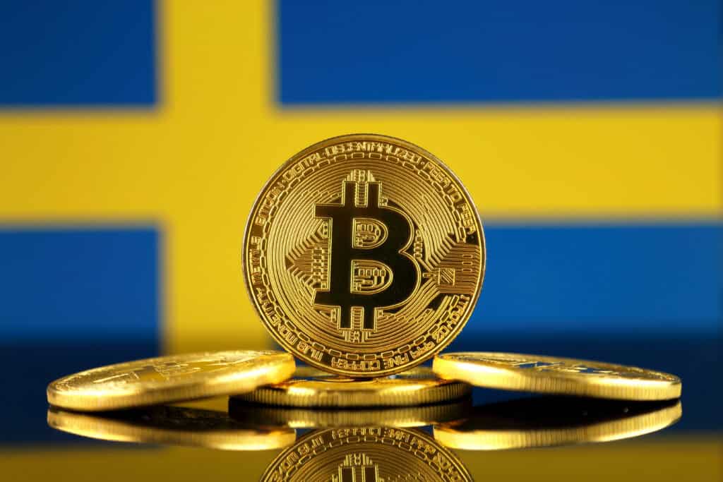 Physical version of Bitcoin (new virtual money) and Sweden Flag.