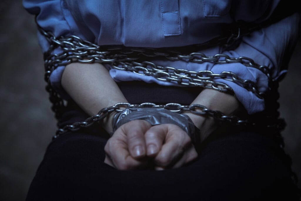 Petite business lady loaded with chains